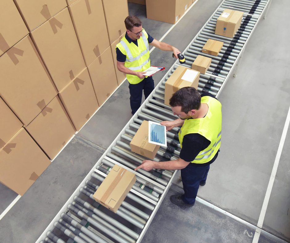 employees checking parcels on warehouse line